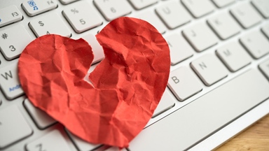 Keyboard paper heart crumpled torn